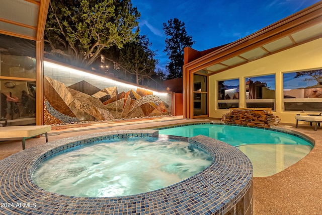 view of swimming pool with an in ground hot tub