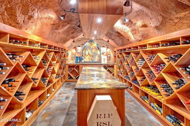 wine area with vaulted ceiling