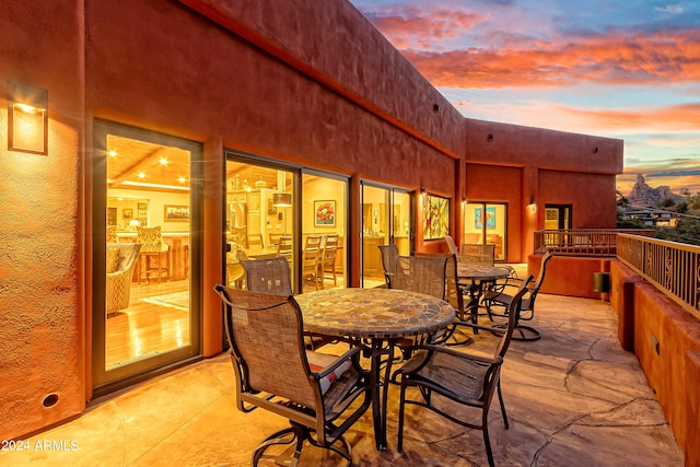 view of patio terrace at dusk