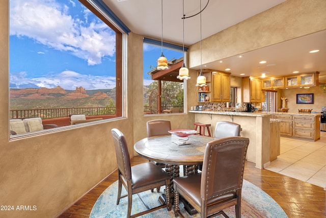 dining space featuring a mountain view, sink, and light wood-type flooring