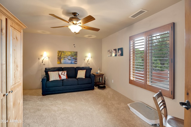 carpeted living room featuring ceiling fan