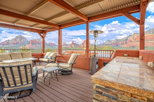 deck featuring an outdoor living space and a mountain view