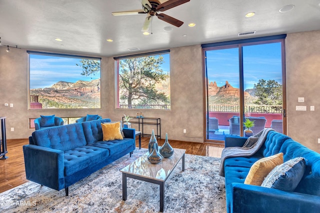 living room with hardwood / wood-style flooring and ceiling fan