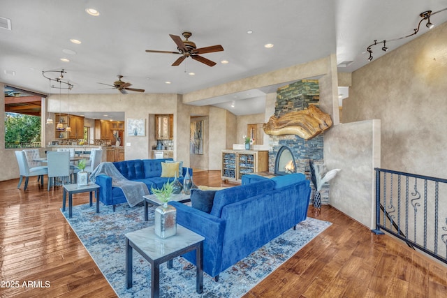 living room featuring hardwood / wood-style floors and a stone fireplace