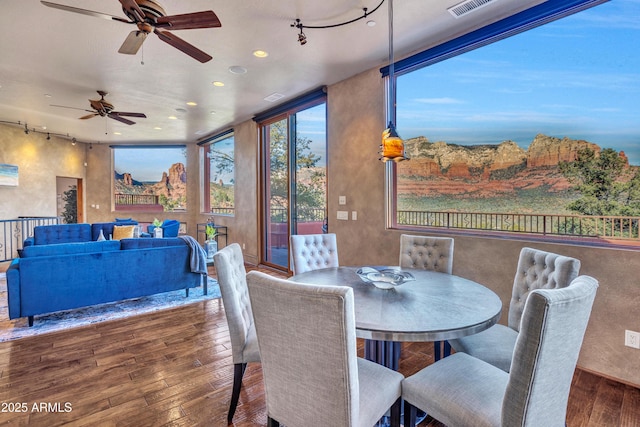 sunroom featuring rail lighting