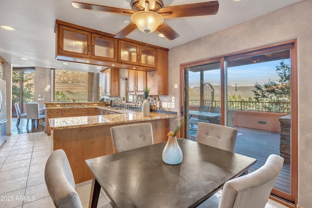 dining area with light tile patterned floors and ceiling fan