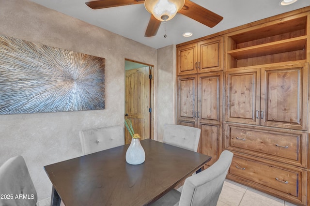 tiled dining room featuring ceiling fan