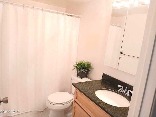 bathroom featuring vanity, toilet, and tile patterned flooring