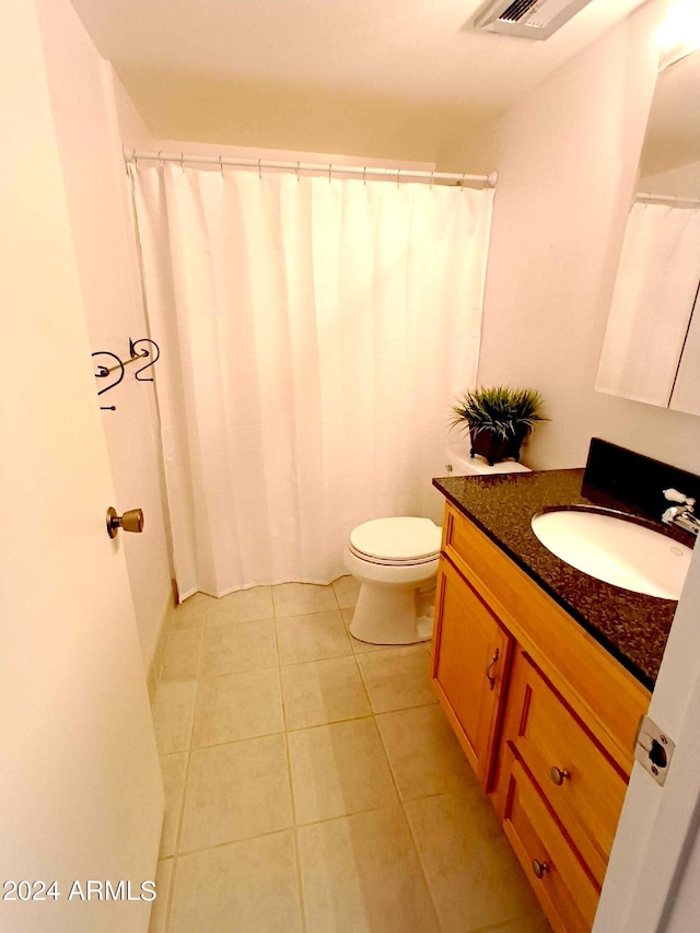 bathroom with vanity, toilet, and tile patterned flooring