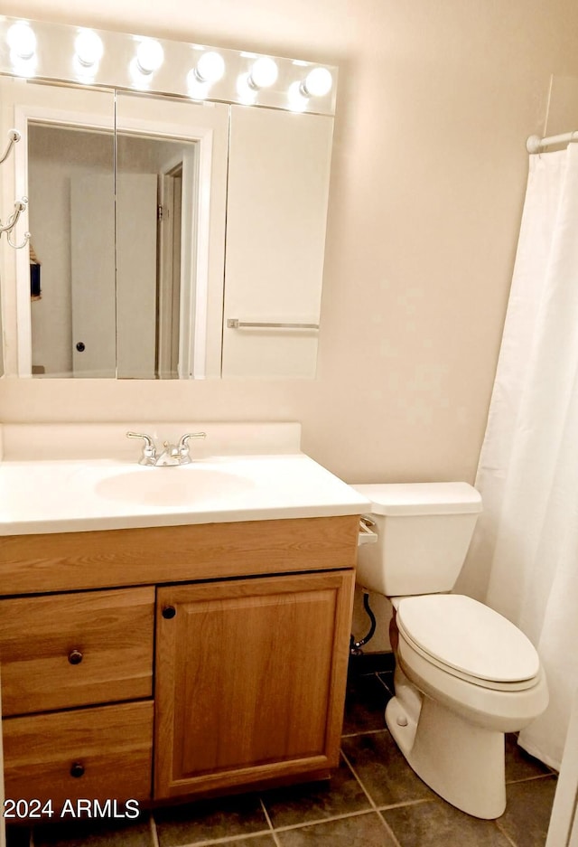 bathroom featuring vanity, toilet, and tile patterned flooring