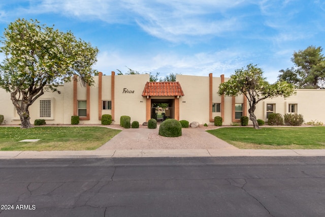 southwest-style home with a front lawn