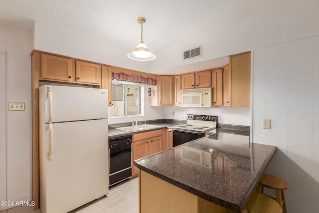 kitchen featuring white appliances, sink, kitchen peninsula, decorative light fixtures, and vaulted ceiling