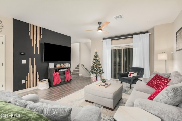 living room featuring ceiling fan and wood-type flooring