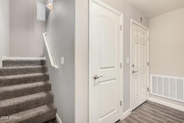 stairway with hardwood / wood-style flooring