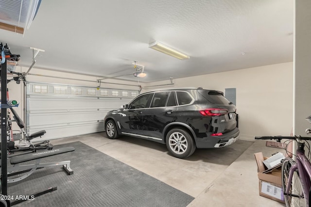 garage with a garage door opener and electric panel