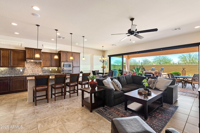 8544 E Kael St, Mesa, AZ 85207 - living area featuring recessed lighting, ceiling fan, a chandelier, and light tile patterned flooring