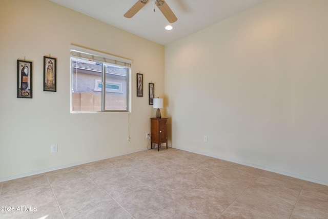 spare room with light tile patterned floors and ceiling fan