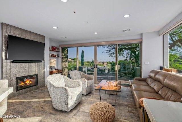 living room featuring a tiled fireplace