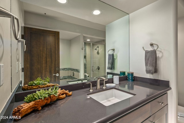 bathroom with walk in shower, vanity, and toilet