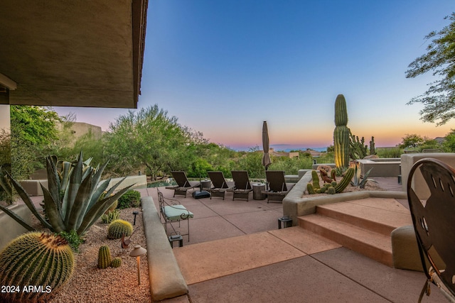 view of patio terrace at dusk