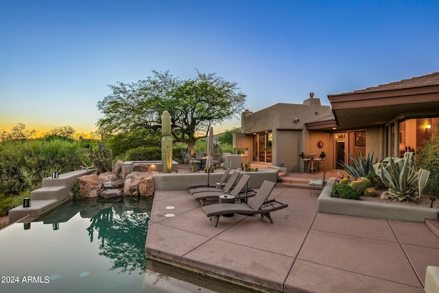 view of patio terrace at dusk