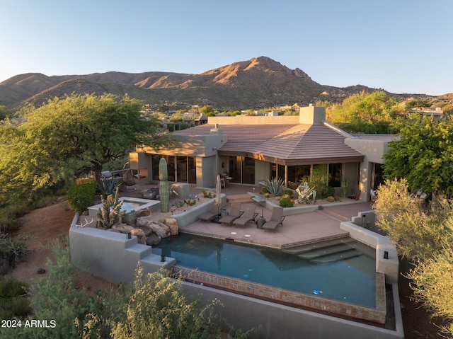 back of house featuring a mountain view and a patio