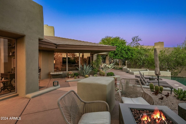 patio terrace at dusk with a fire pit