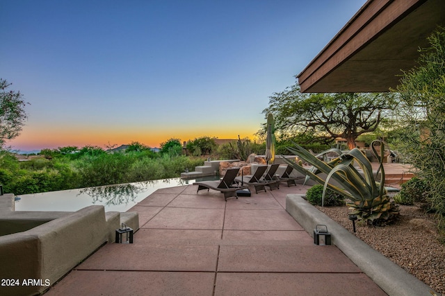 view of patio terrace at dusk