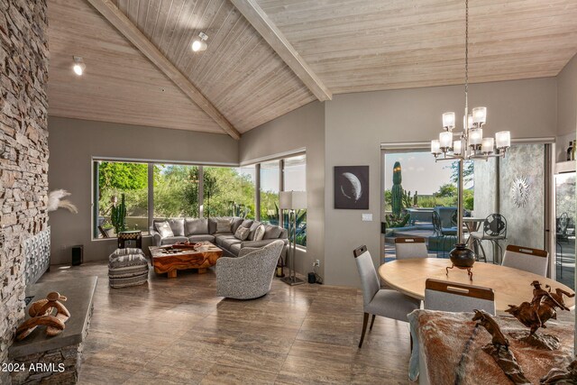 living room with beamed ceiling, wood ceiling, an inviting chandelier, and high vaulted ceiling