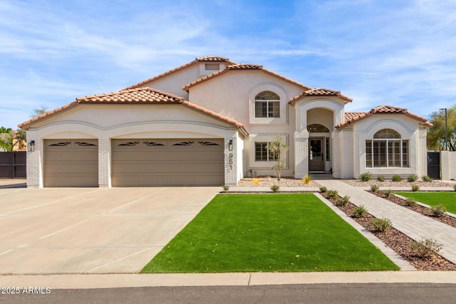 mediterranean / spanish-style home featuring driveway, an attached garage, a front yard, and stucco siding