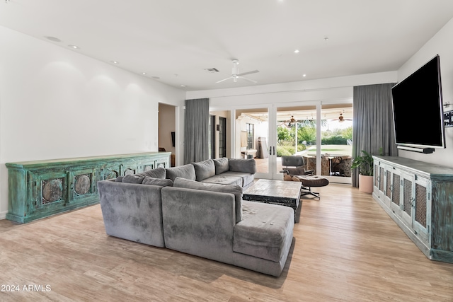 living room with ceiling fan and light hardwood / wood-style floors