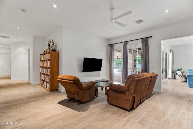 living room featuring french doors, light hardwood / wood-style floors, and ceiling fan