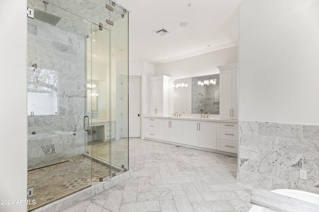 bathroom featuring a shower with door, vanity, and tile walls