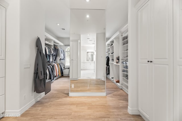 walk in closet featuring light hardwood / wood-style flooring