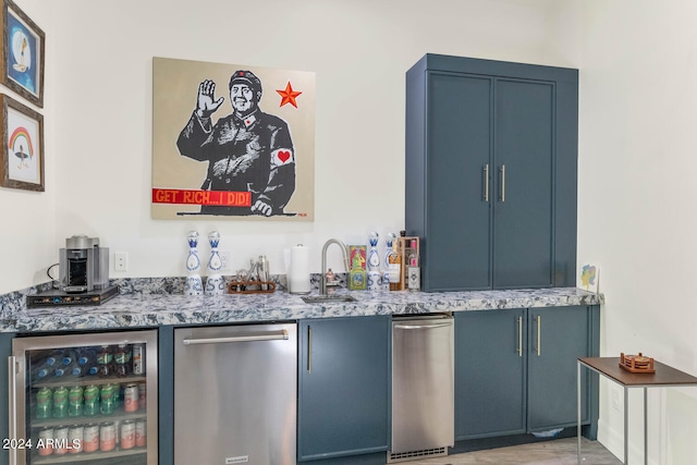 bar featuring blue cabinetry, wine cooler, stainless steel dishwasher, and light stone counters