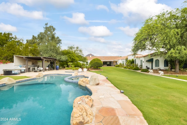 view of swimming pool featuring a lawn, a patio area, and an in ground hot tub