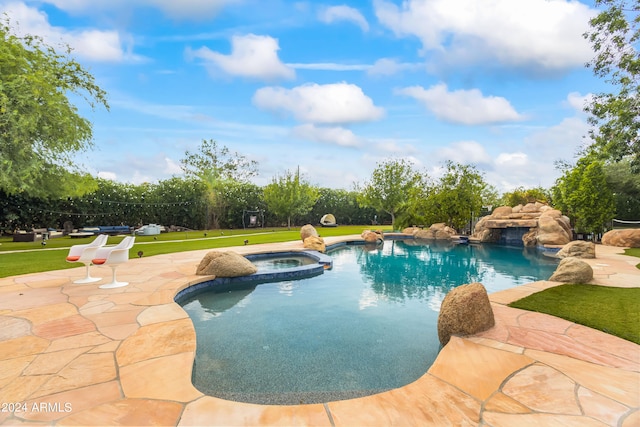 view of pool featuring a lawn, a patio area, and an in ground hot tub