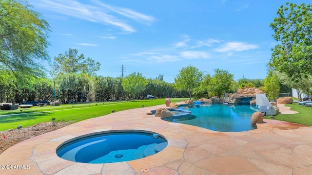 view of swimming pool with a patio area, an in ground hot tub, and a yard