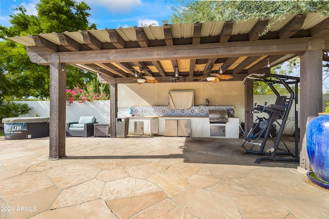 view of patio / terrace with an outdoor kitchen, ceiling fan, and area for grilling