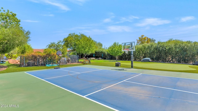 view of basketball court with a lawn