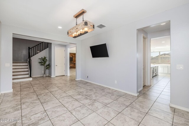 9645 E Theia Dr, Mesa, AZ 85212 - unfurnished room with light tile patterned flooring, stairs, recessed lighting, and baseboards