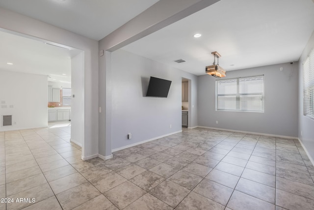 unfurnished living room with light tile patterned flooring