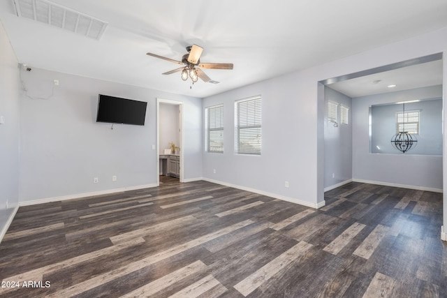 9645 E Theia Dr, Mesa, AZ 85212 - unfurnished living room featuring plenty of natural light, dark wood-style floors, ceiling fan, and baseboards