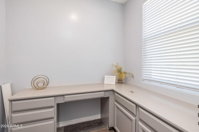 office space with dark hardwood / wood-style flooring and built in desk