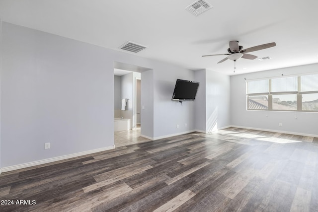 empty room featuring ceiling fan and dark wood-type flooring