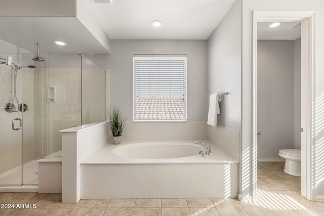 bathroom featuring tile patterned floors, separate shower and tub, and toilet