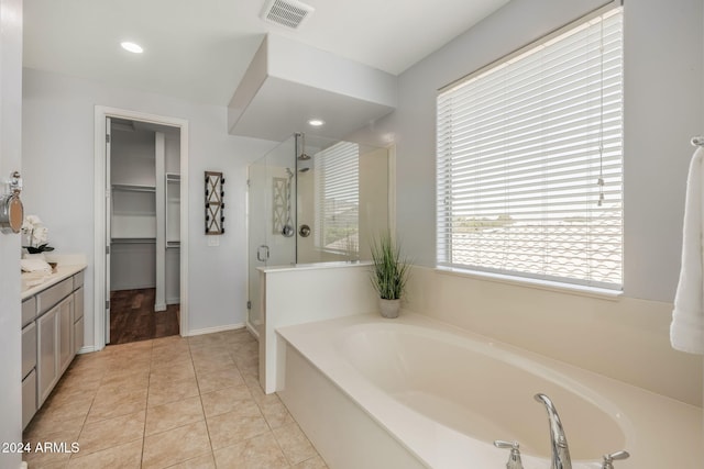 bathroom featuring shower with separate bathtub, tile patterned flooring, and vanity