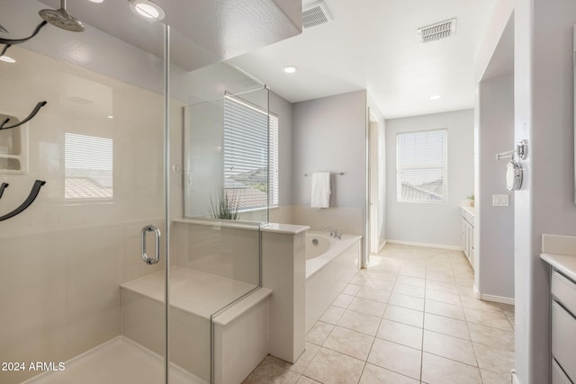 bathroom with tile patterned flooring, vanity, and independent shower and bath