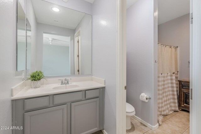 9645 E Theia Dr, Mesa, AZ 85212 - bathroom featuring tile patterned flooring, toilet, vanity, a ceiling fan, and a shower with shower curtain