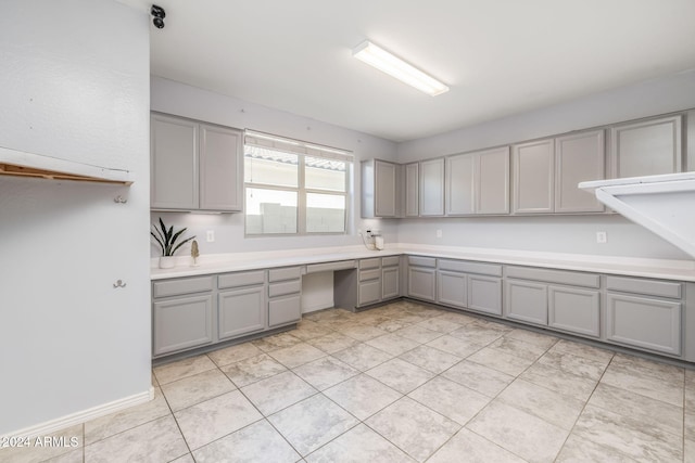 kitchen with gray cabinetry and light tile patterned flooring